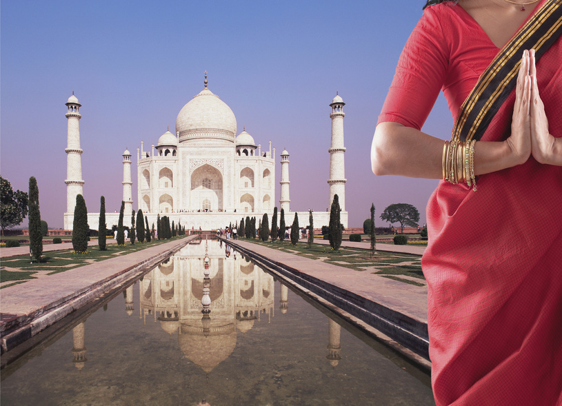 Indian woman in traditional clothing near the Taj Mahal